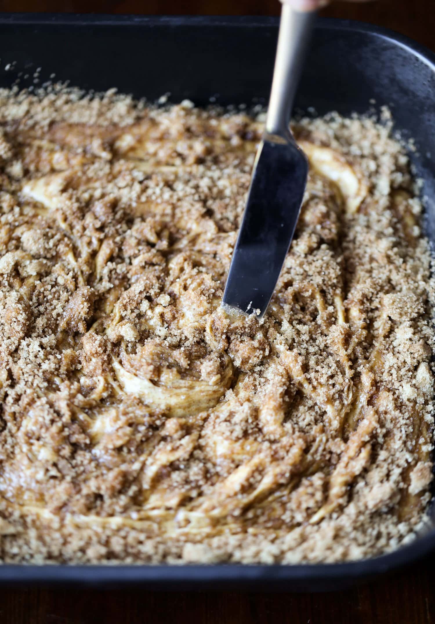 swirling cinnamon sugar into pumpkin cake