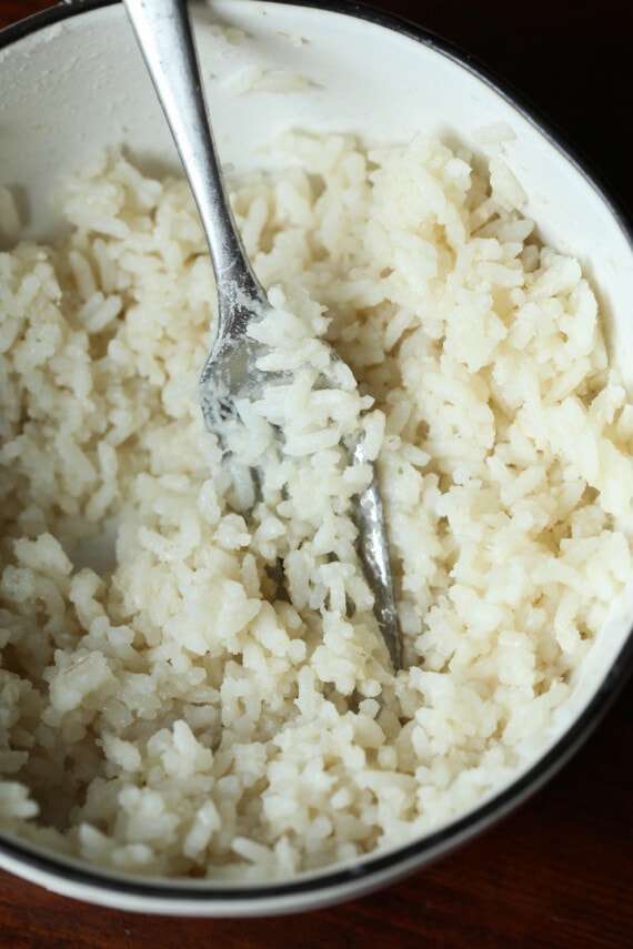 mashed rice with a fork in a bowl