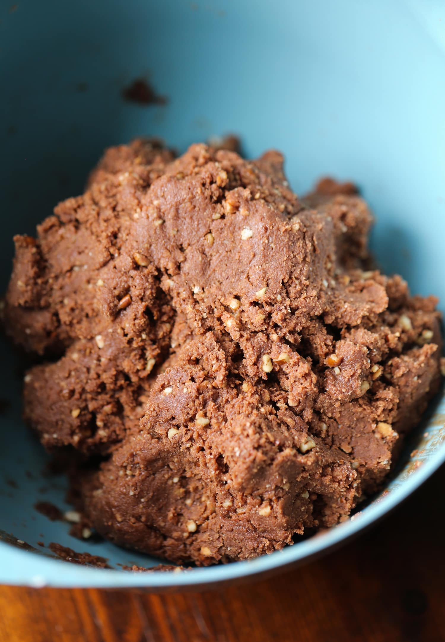 Rum balls dough in a blue mixing bowl.