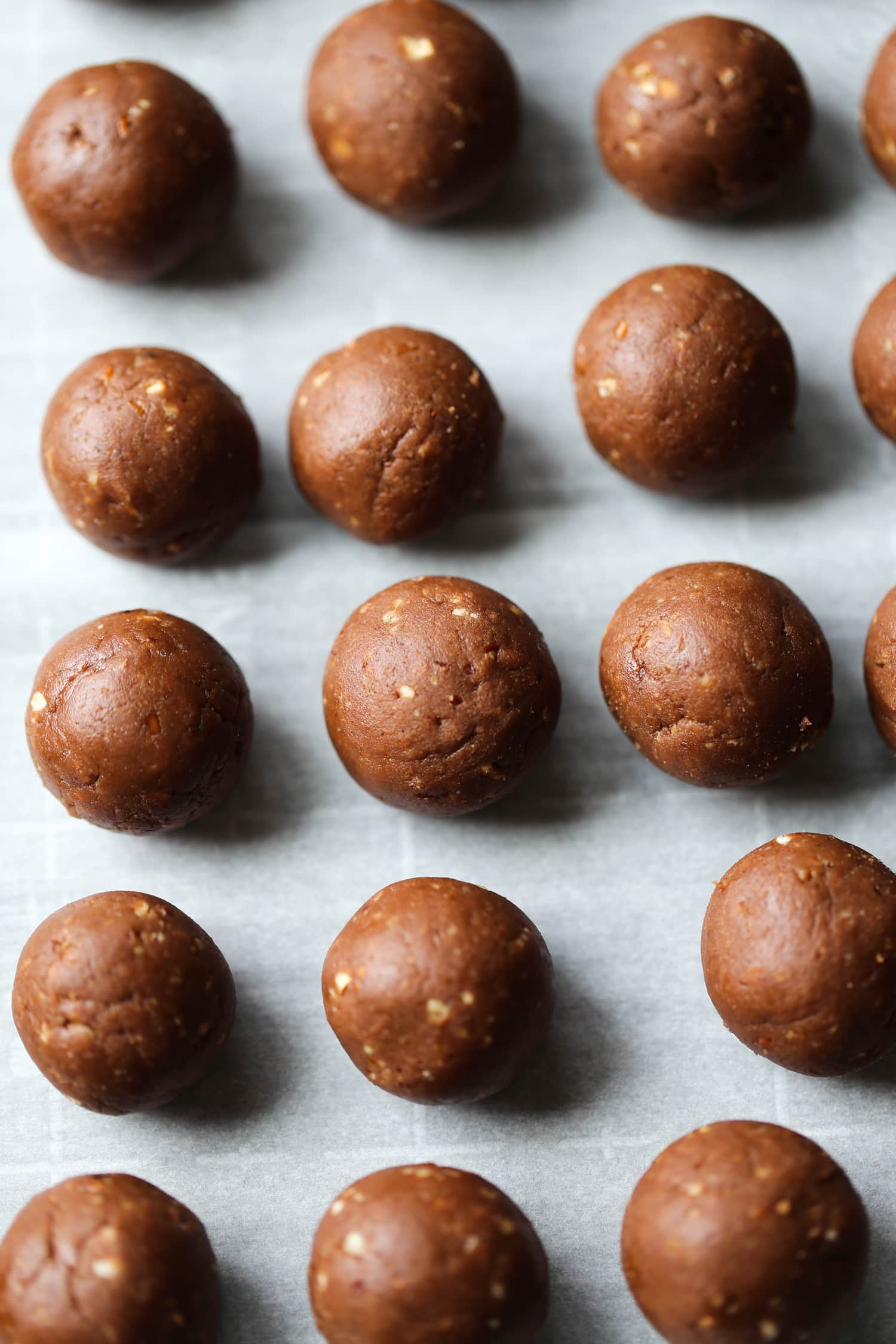 Rolled rum balls on parchment.