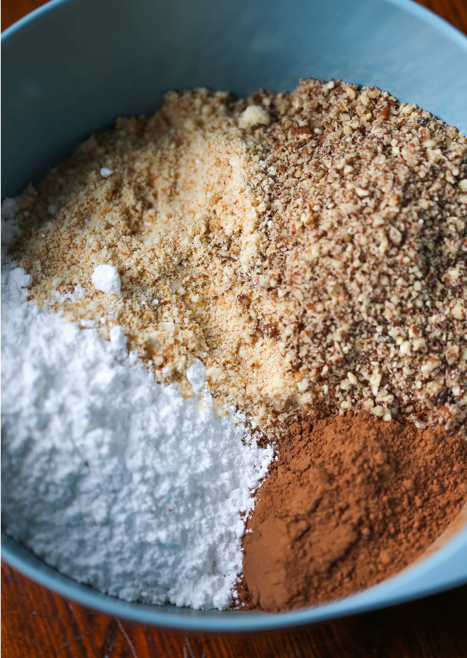 The ingredients for holiday rum balls are combined in a mixing bowl.