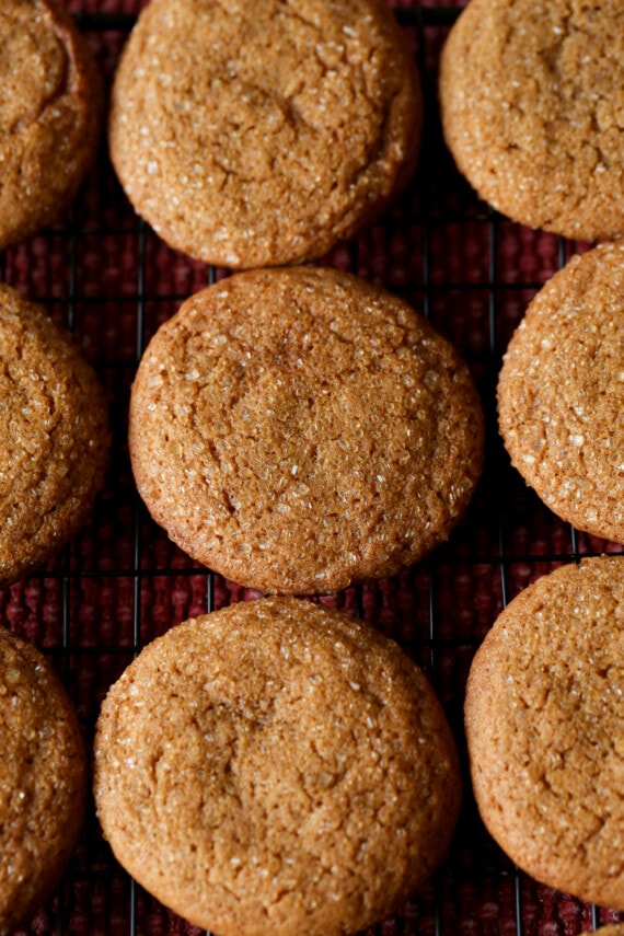 Soft gingerbread cookies on a cooling rack topped with coarse sugar