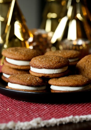 Soft Gingerbread Cookie Sandwiches on a plate with Christmas decor