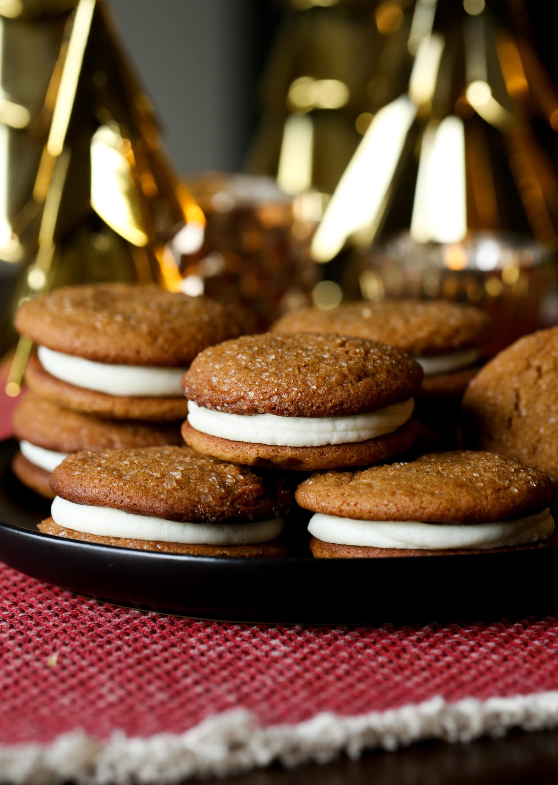 Soft Gingerbread Cookie Sandwiches on a plate with Christmas decor