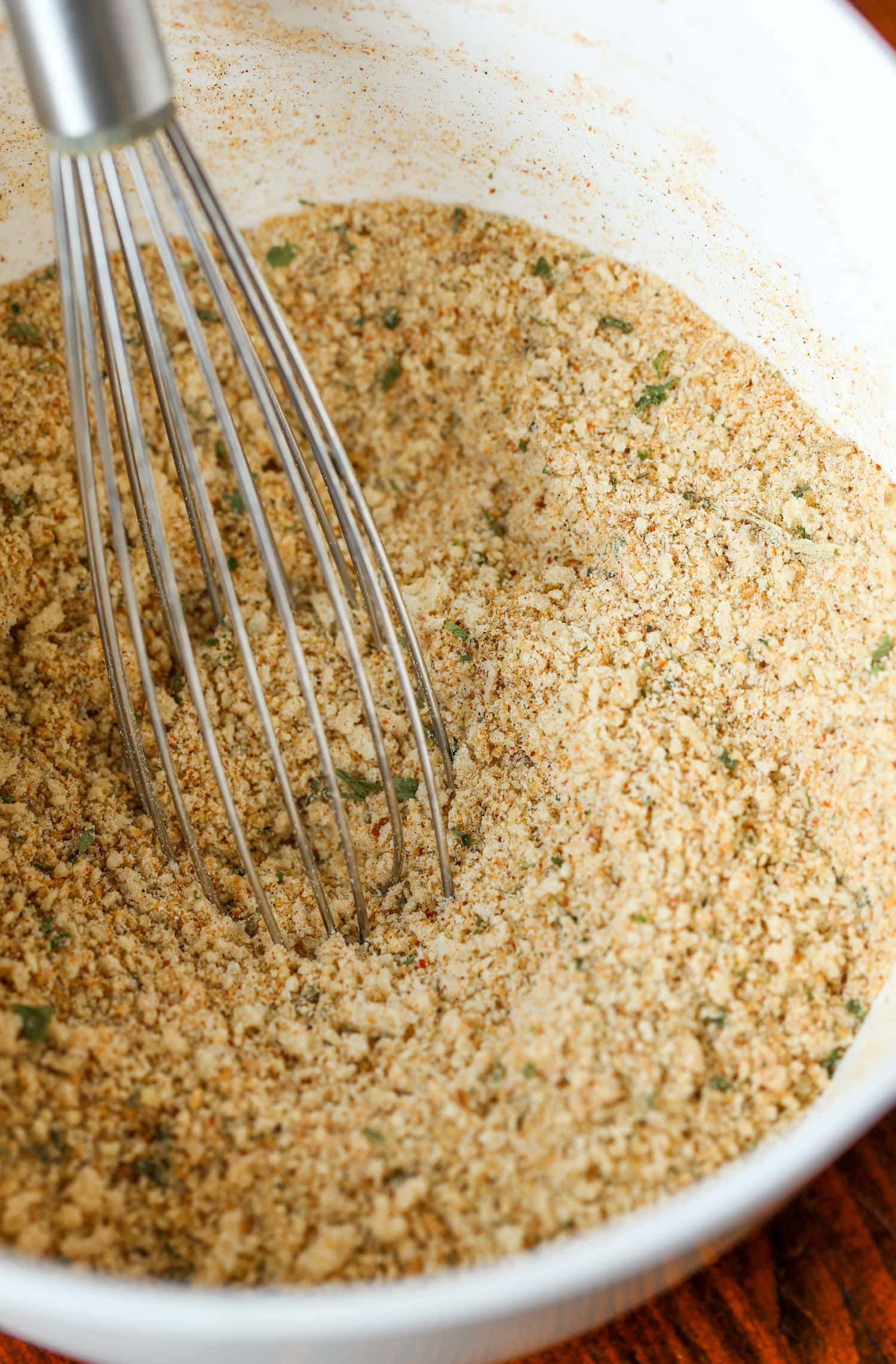 Whisking together the ingredients for the spicy breadcrumb coating.