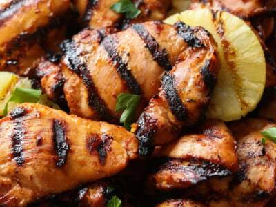 Hawaiian grilled huli huli chicken thighs with pineapple on a plate.