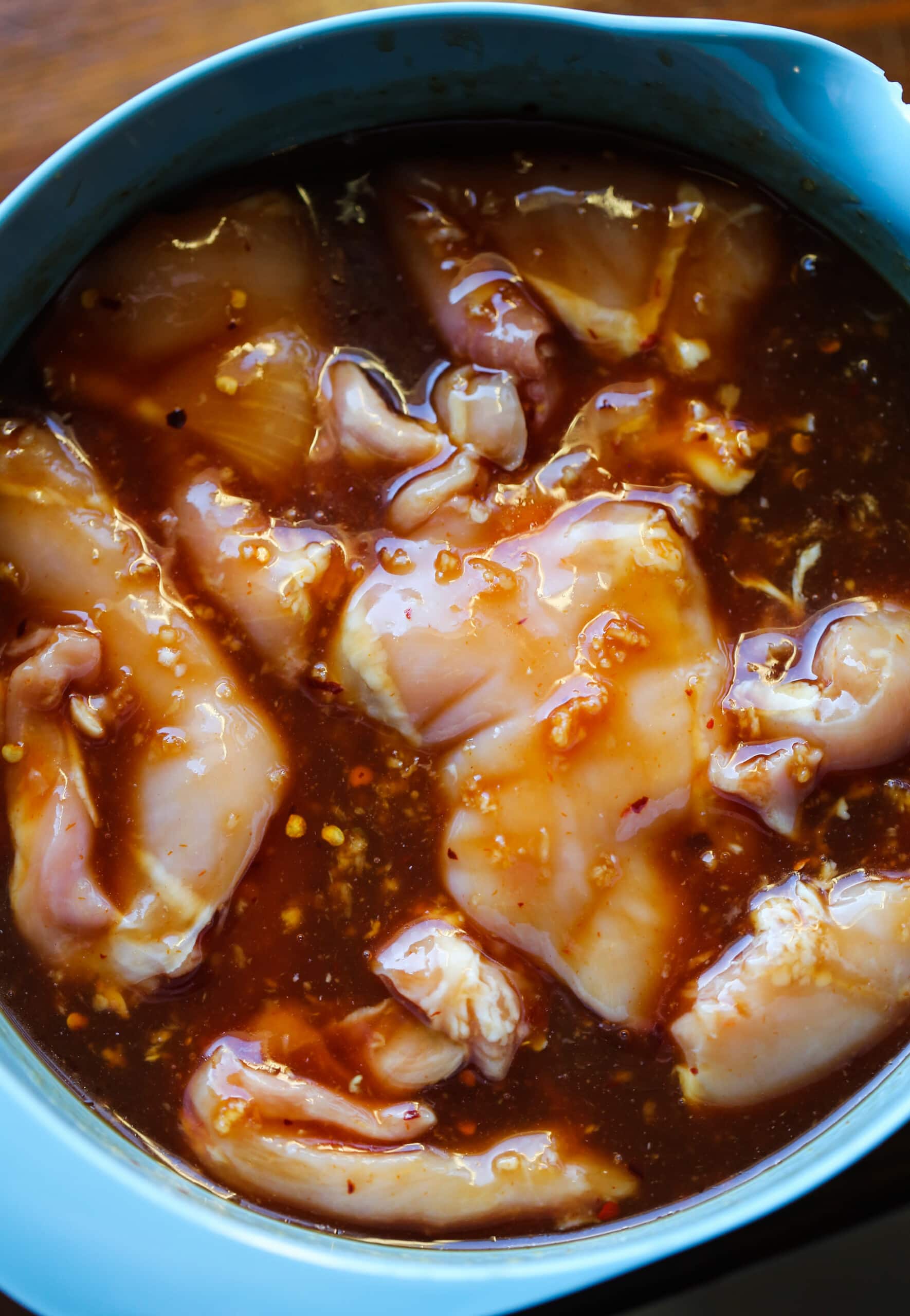 Chicken thighs marinading in huli huli sauce.