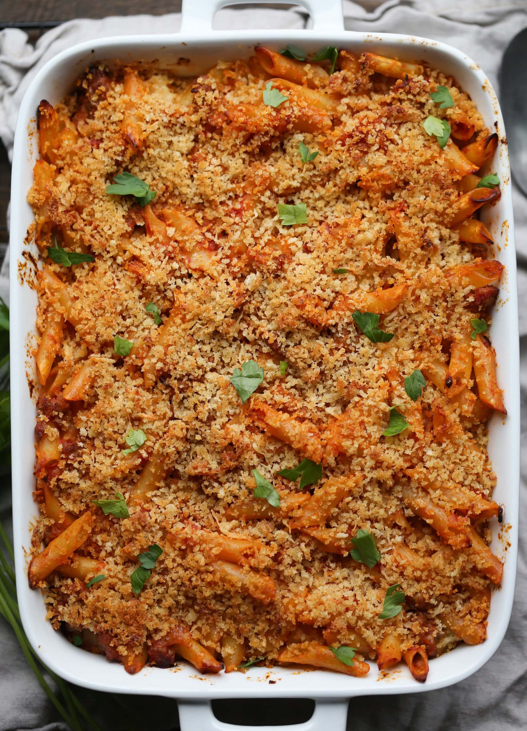 Baked mostaccioli topped with parmesan cheese, breadcrumbs and fresh herbs.