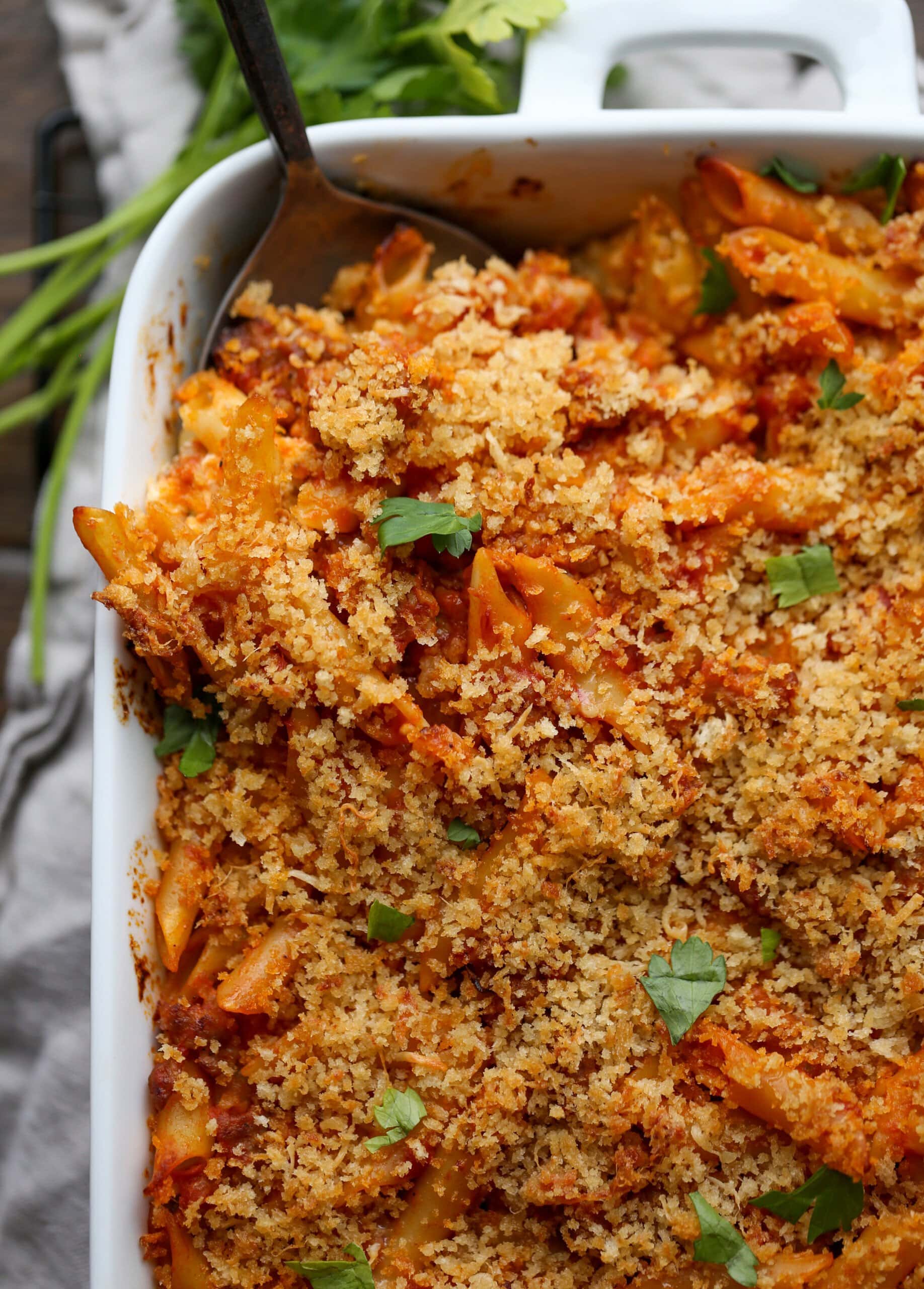 Baked mostaccioli topped with parmesan cheese, breadcrumbs and fresh herbs.