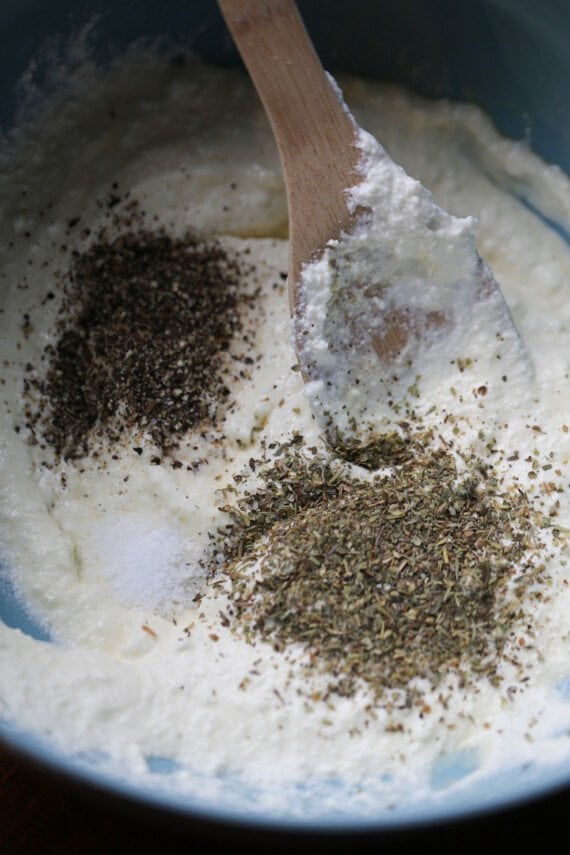 Herbs and seasonings are combined with ricotta cheese.