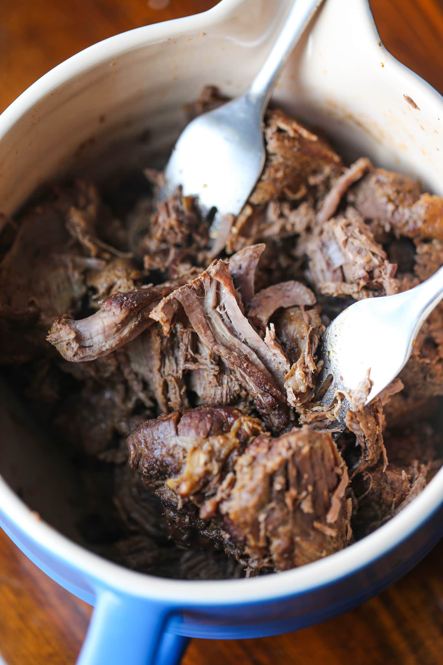 shredding beef with forks