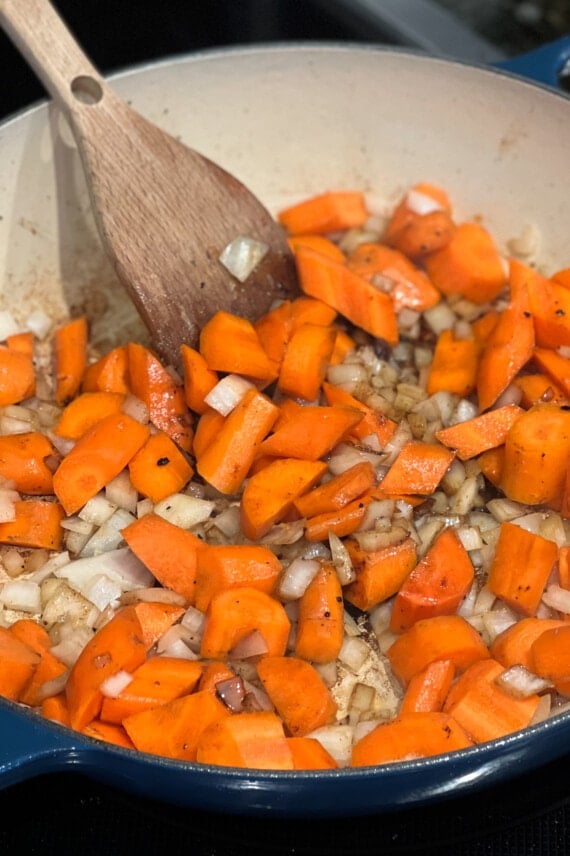 carrots and onions cooking in a dish