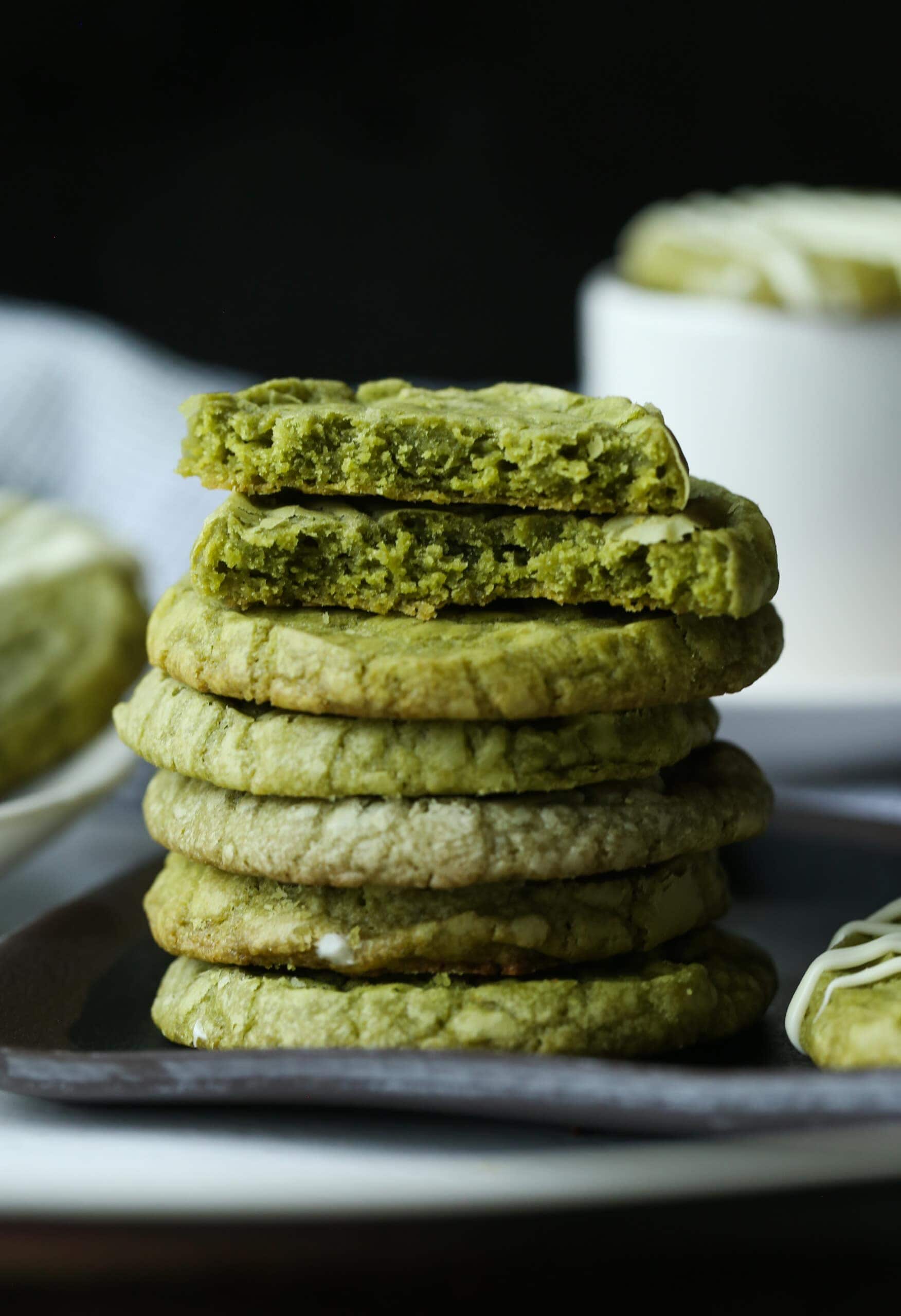 Matcha Shortbread cookies stacked with one broken in hlaf