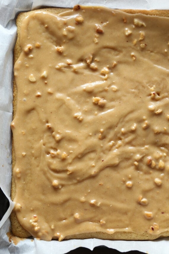 Peanut butter cake batter is spread evenly in a jelly roll pan.
