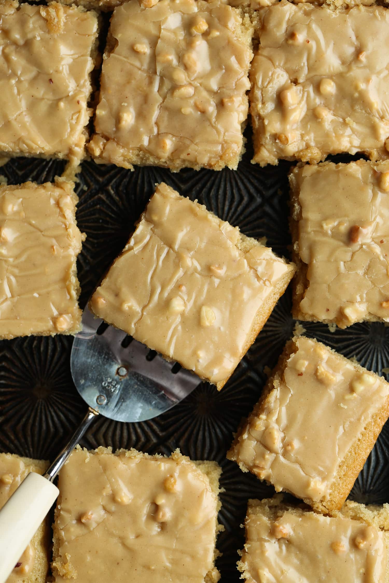 Square slices of peanut butter sheet cake with peanut butter frosting.