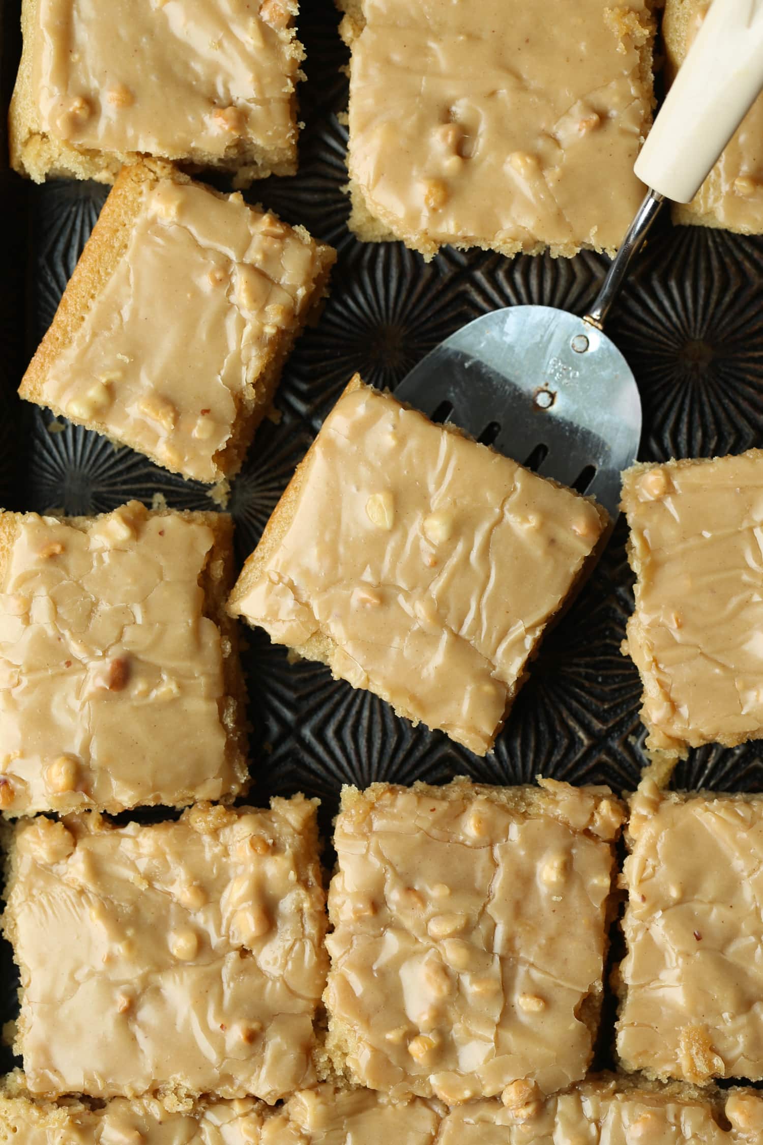 Slices of peanut butter sheet cake with peanut butter frosting.