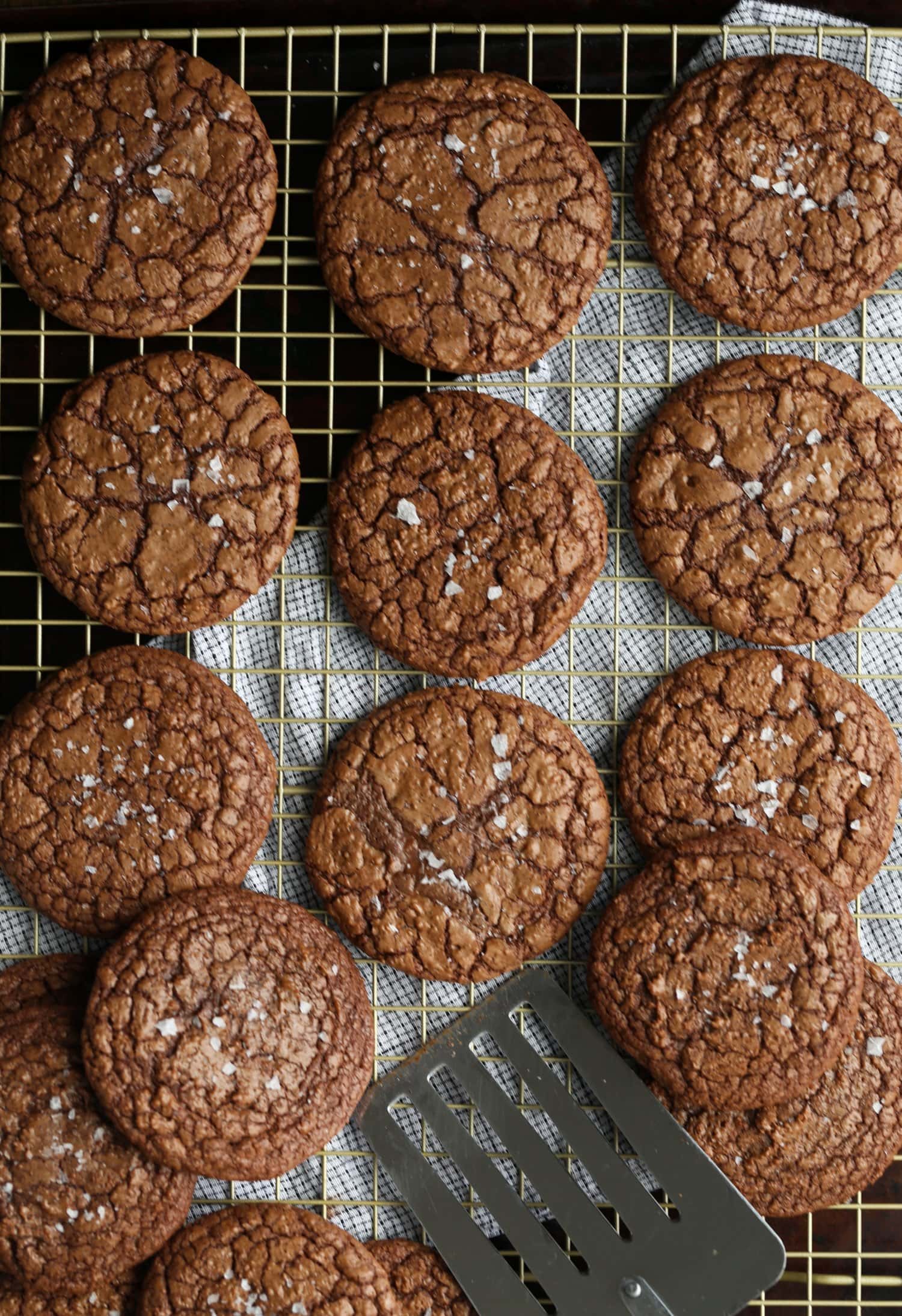 Salted chocolate cookies on a wire rack.