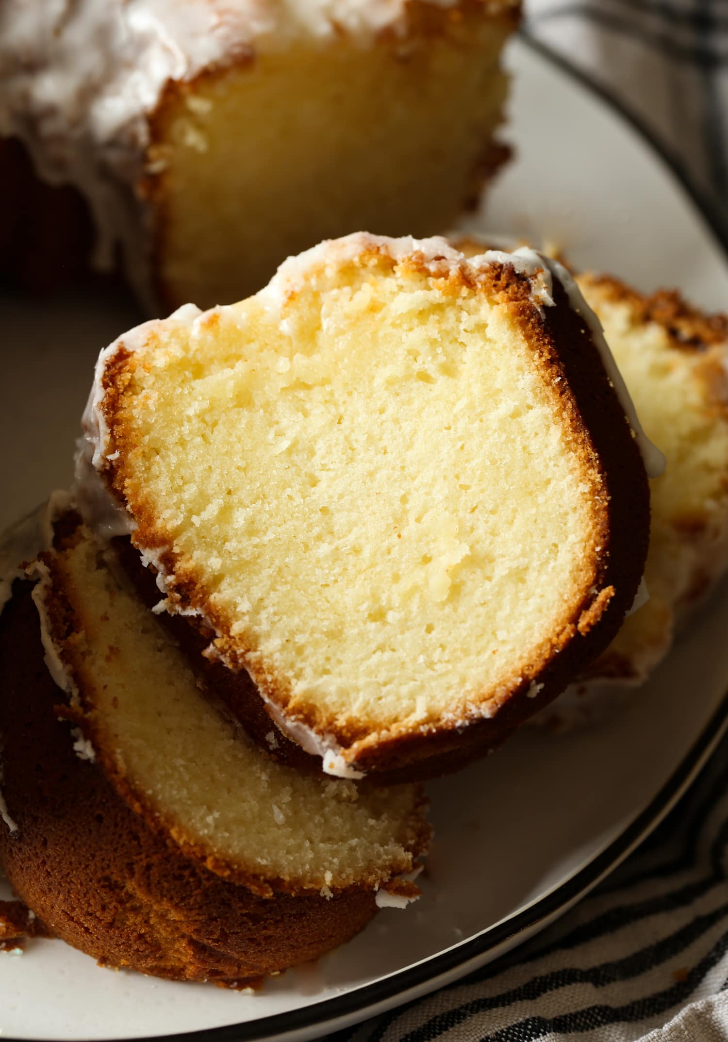 Close up of cake slices next to a 7UP bundt cake on a plate.