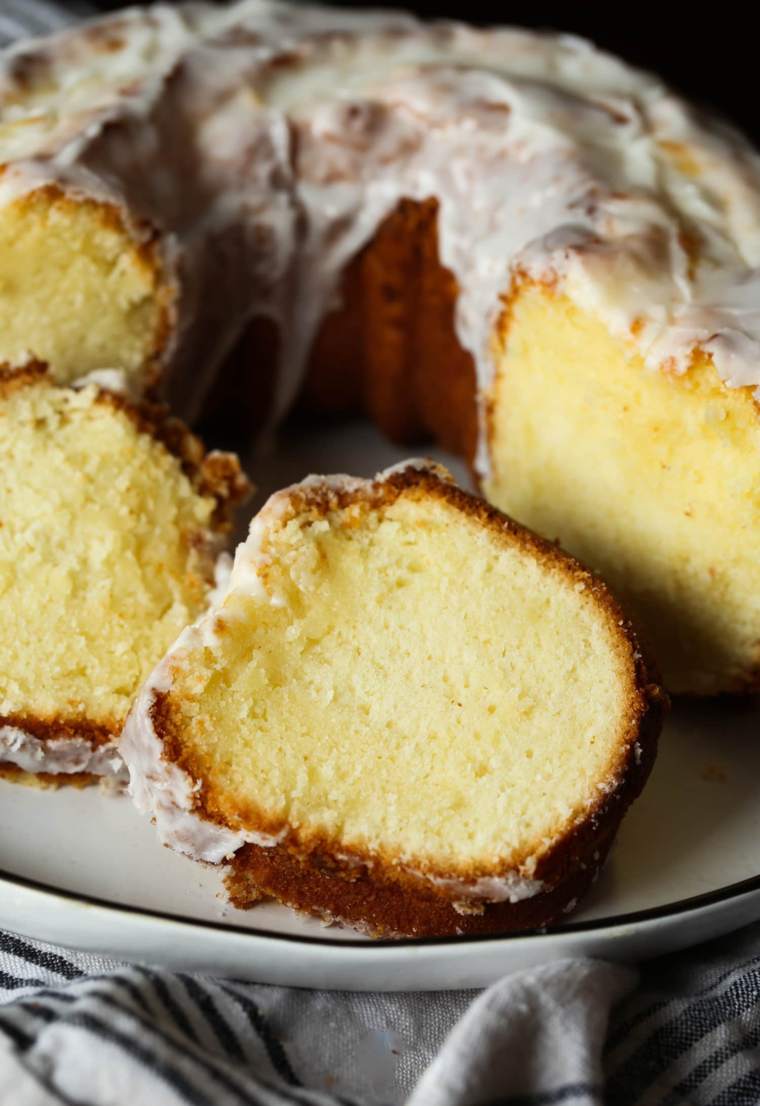 Close up of cake slices next to a 7UP bundt cake on a plate.