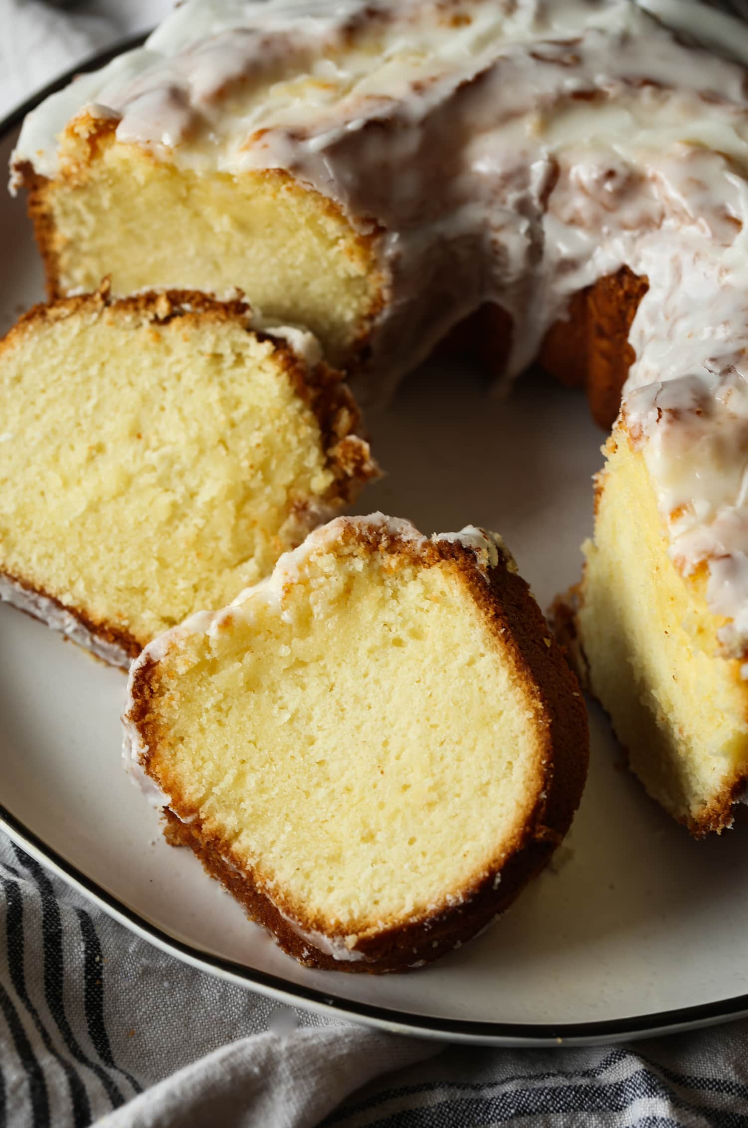 Close up of cake slices next to a 7UP bundt cake on a plate.