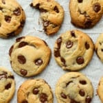 air fryer chocolate chip cookies on the air fryer rack with parchment paper