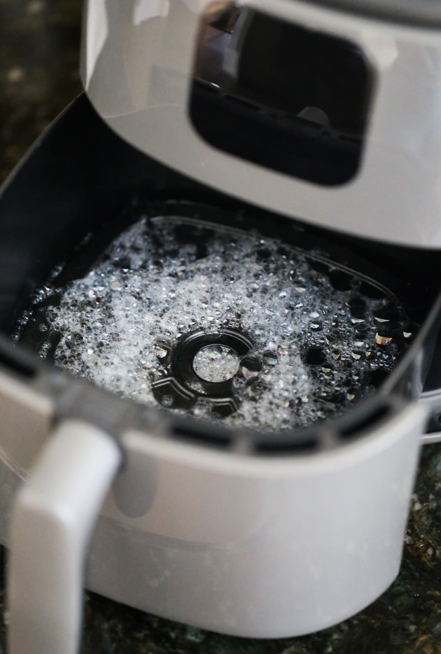 Cleaning a basket style air fryer with soap and water