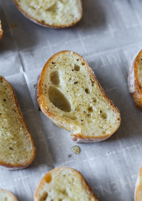 Crispy bruschetta toasts brushed with olive oil.