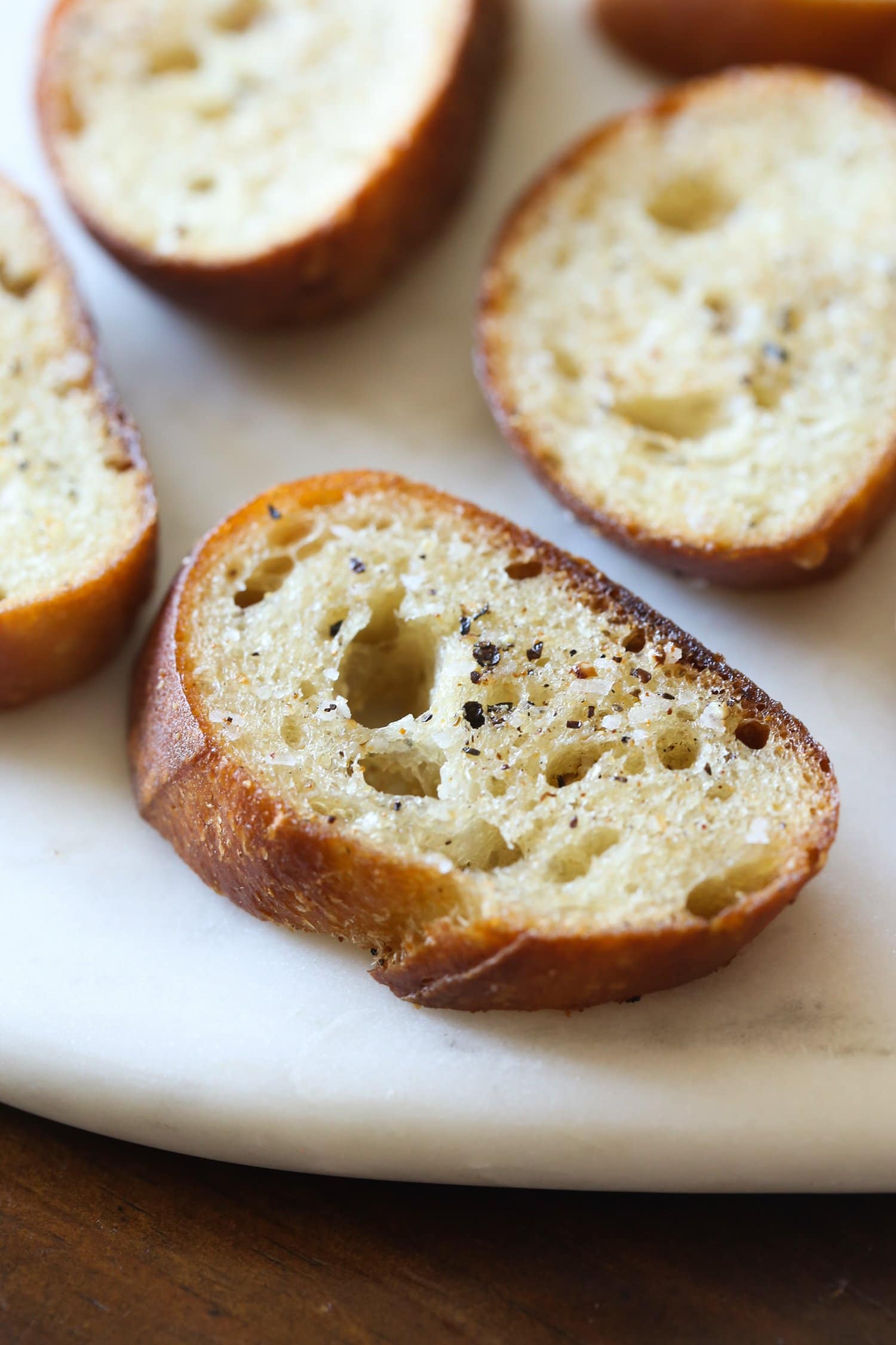 Crispy bruschetta toasts brushed with olive oil.