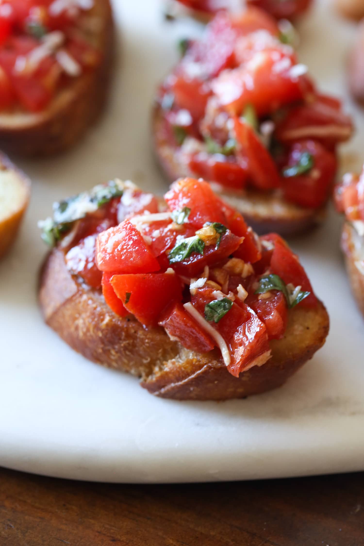 Slices of toasted bread topped with bruschetta.