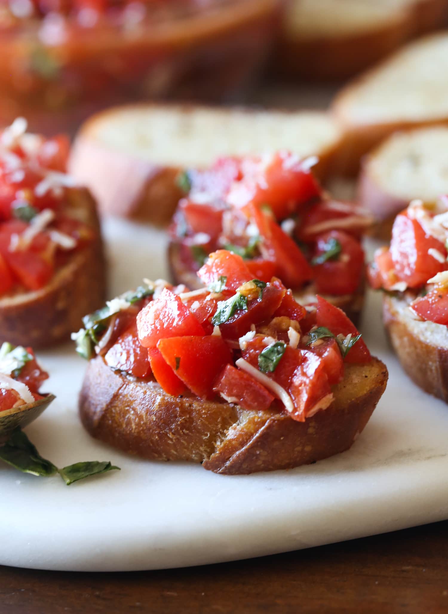 Slices of toasted bread topped with bruschetta.