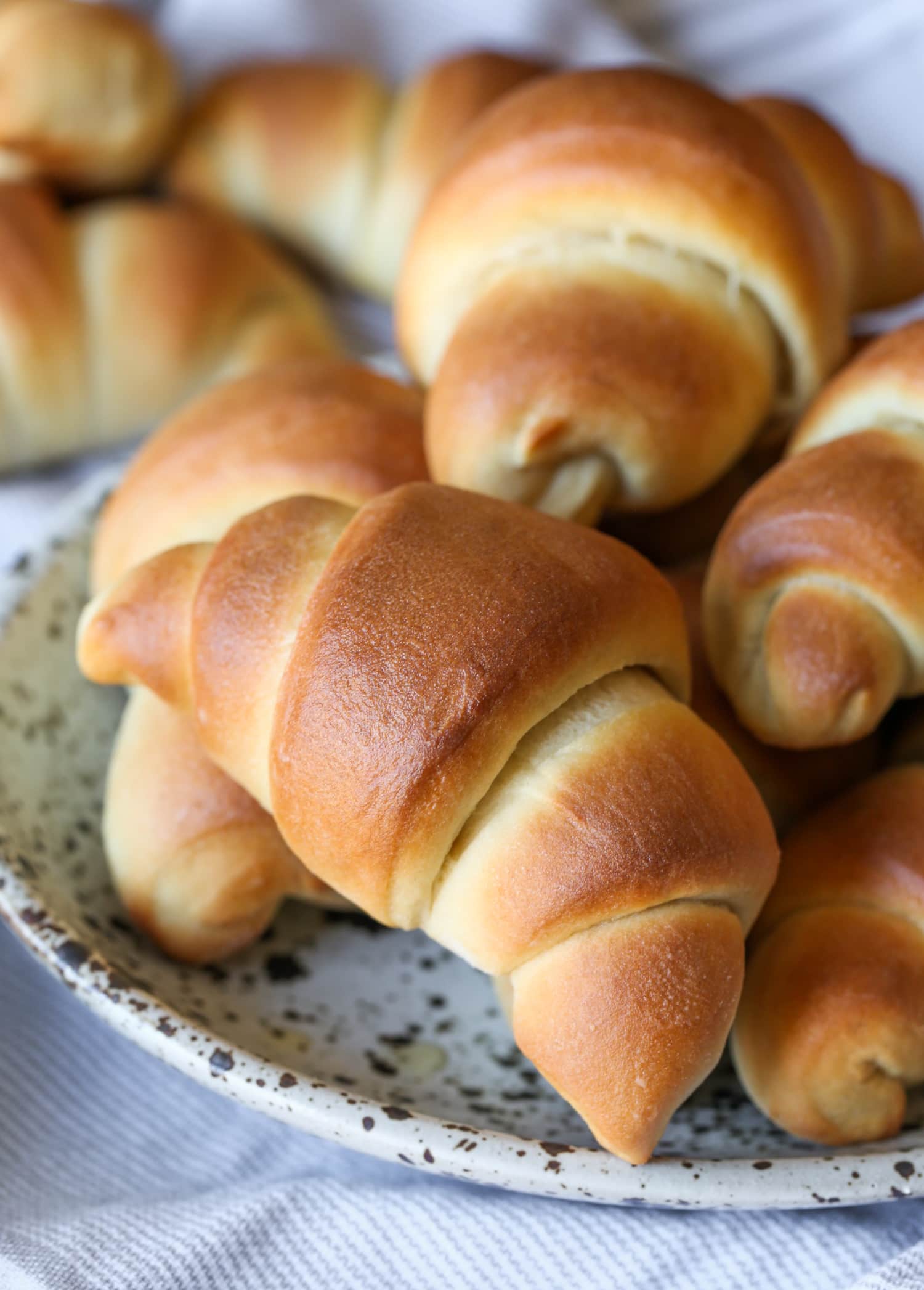 An assortment of golden baked crescent rolls.