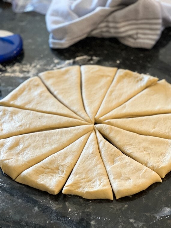 A circle of crescent roll dough cut into 12 even-sized wedges.