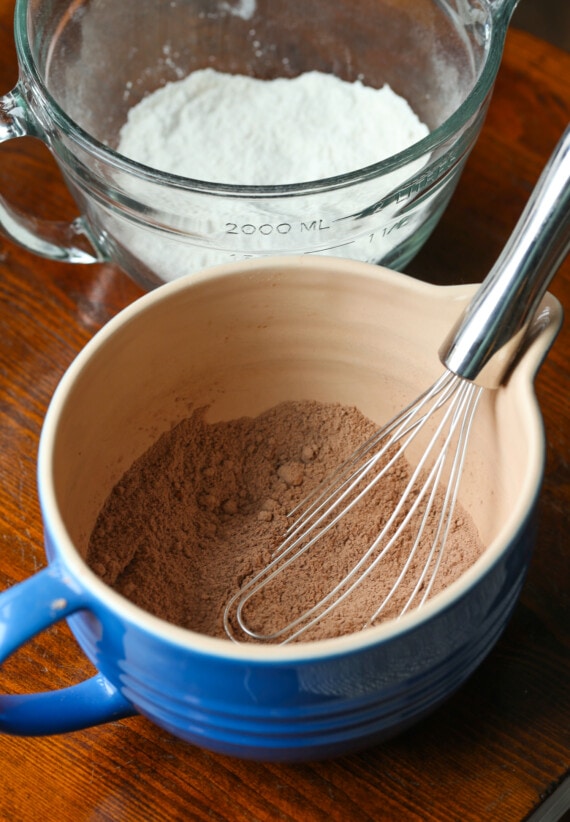 The dry ingredients for the chocolate banana bread batter are whisked together in a large mug.