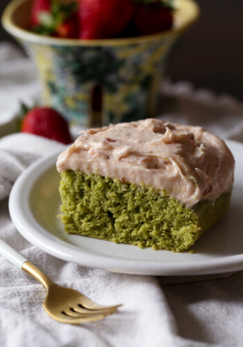 slice of matcha cake with strawberry frosting