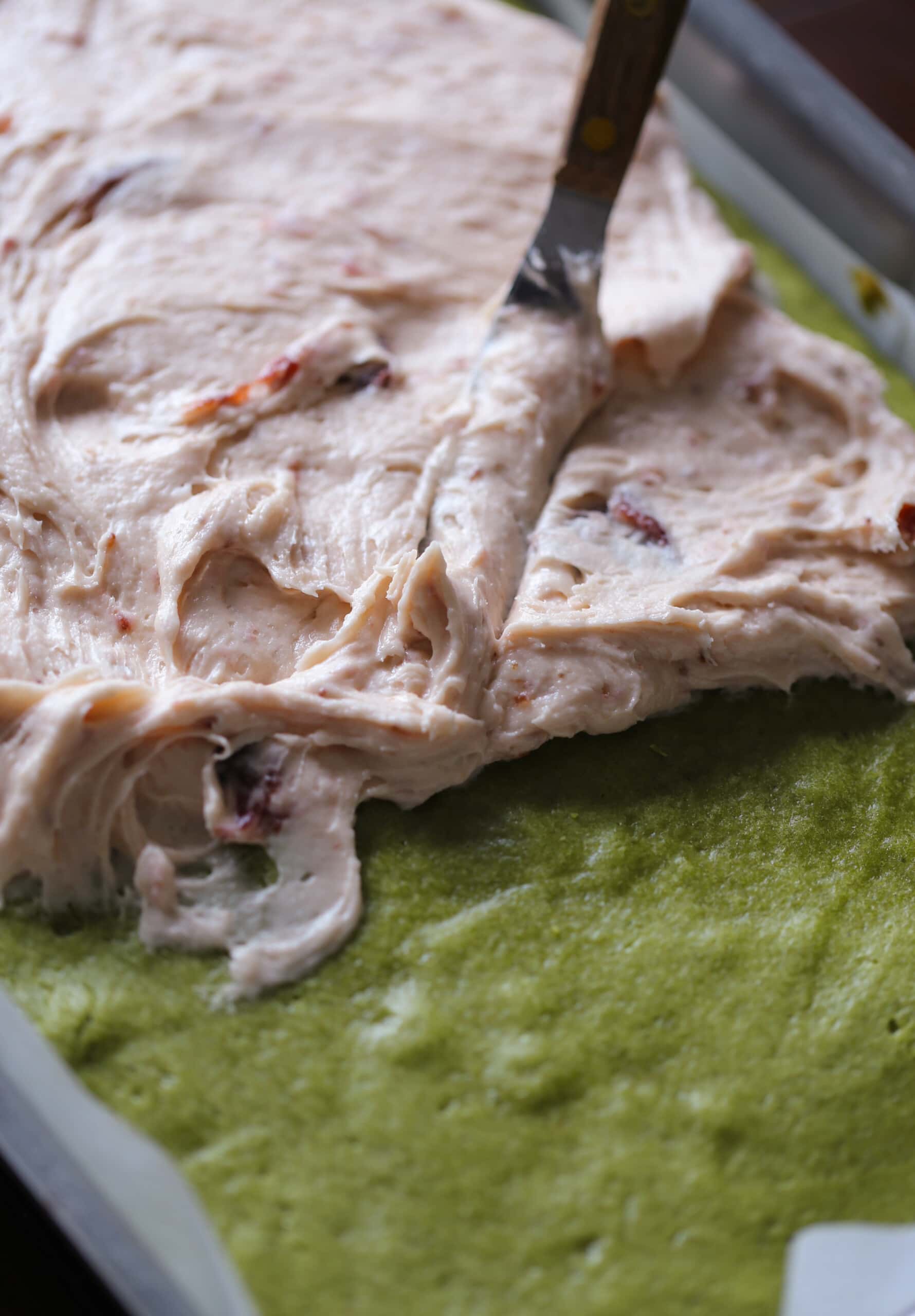 frosting a matcha cake with buttercream