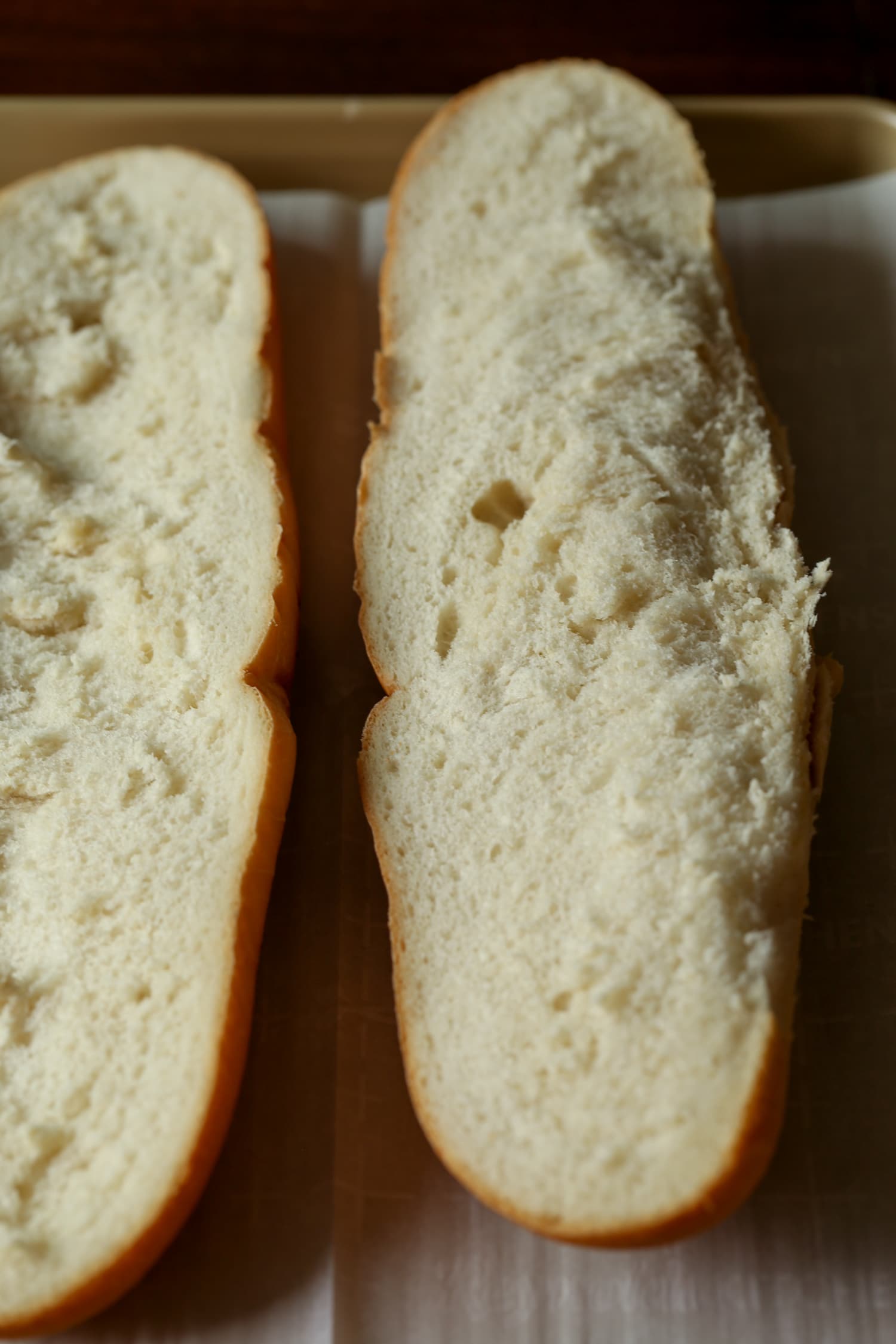 A French bread loaf cut in half lengthwise.