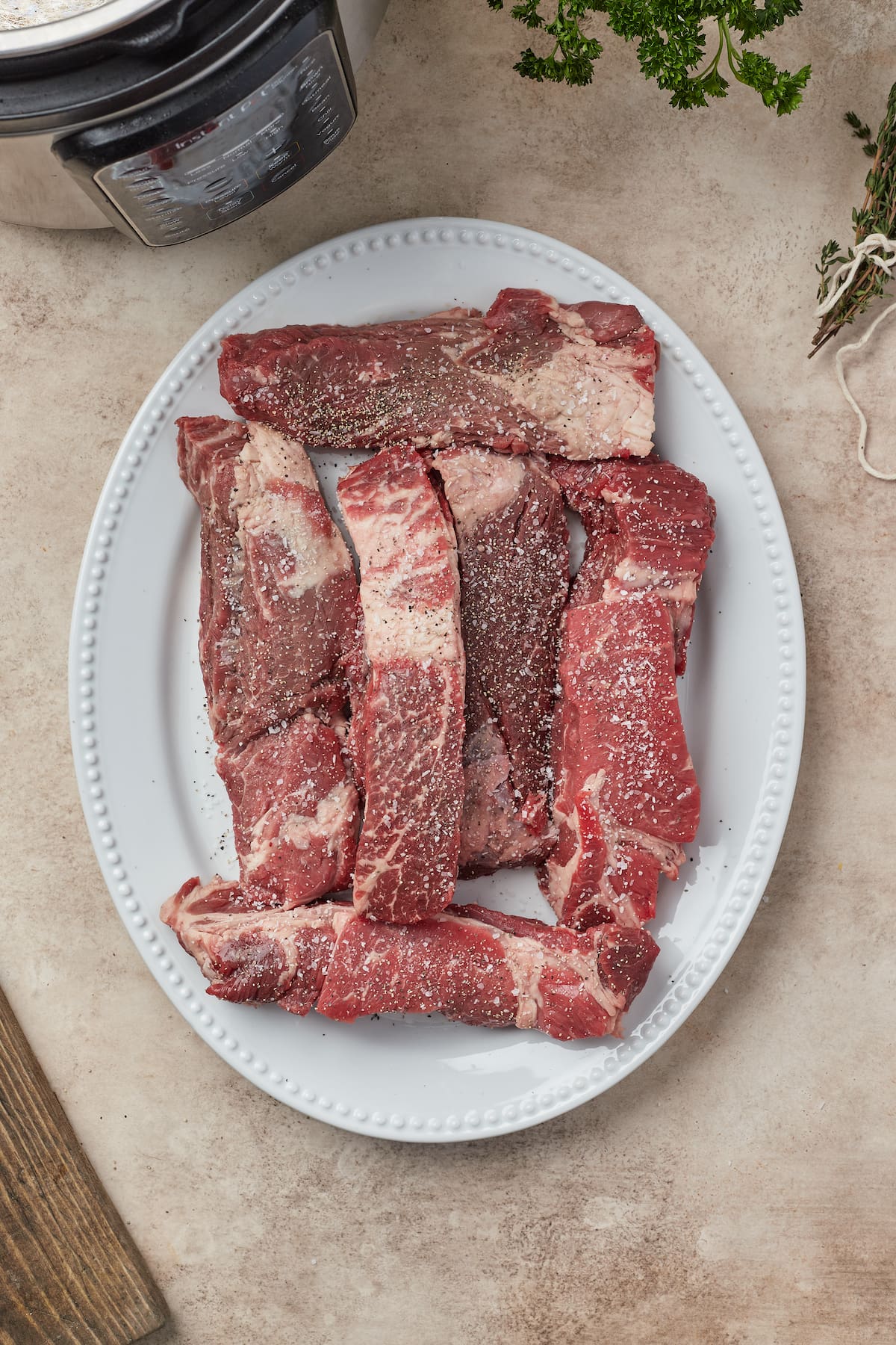 Seasoned beef short ribs on a plate.