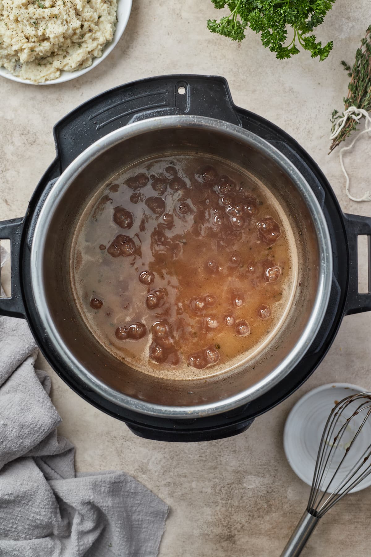 Red wine sauce simmering inside the Instant Pot to reduce.