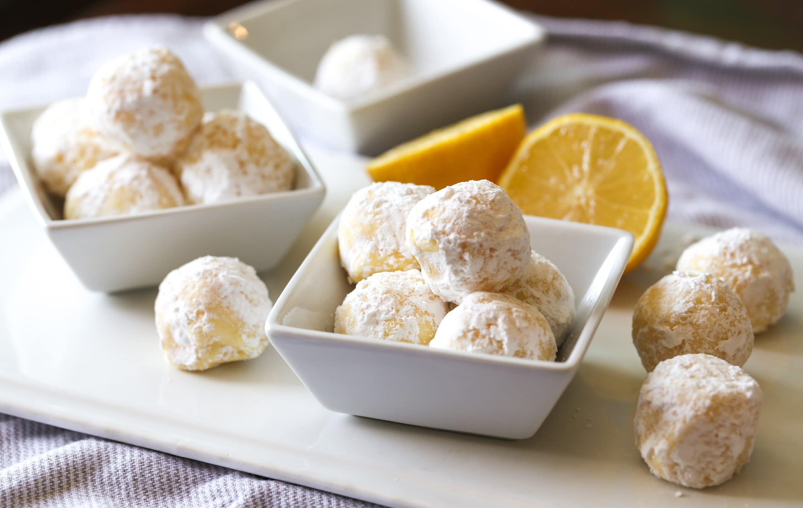 Lemon Truffles coated in powdered sugar in a bowl