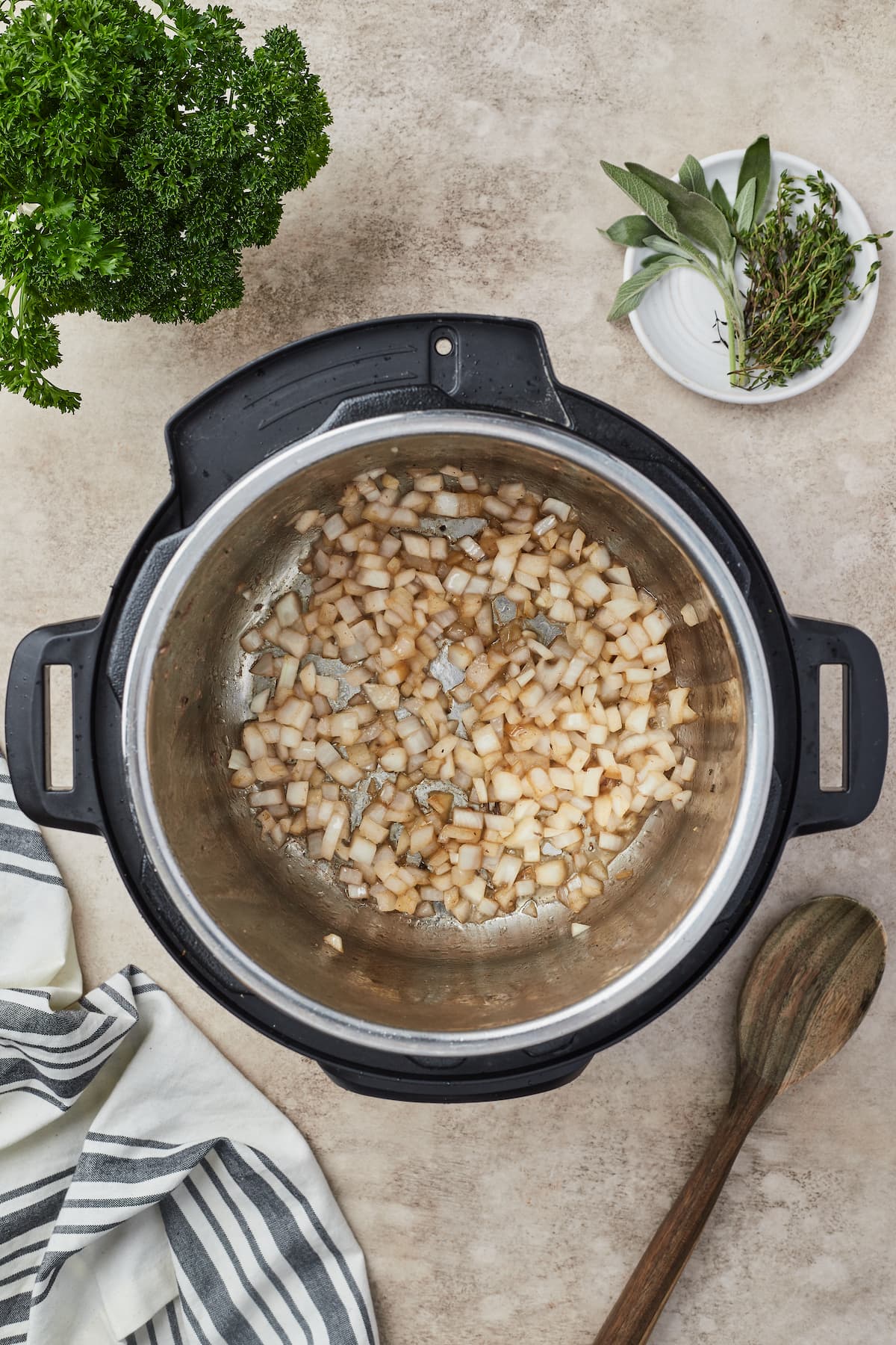 Onions caramelizing in the bowl of an Instant Pot.