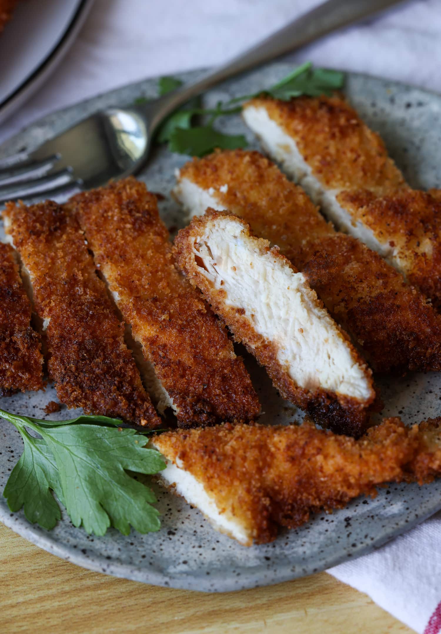 sliced chicken cutlets on a plate