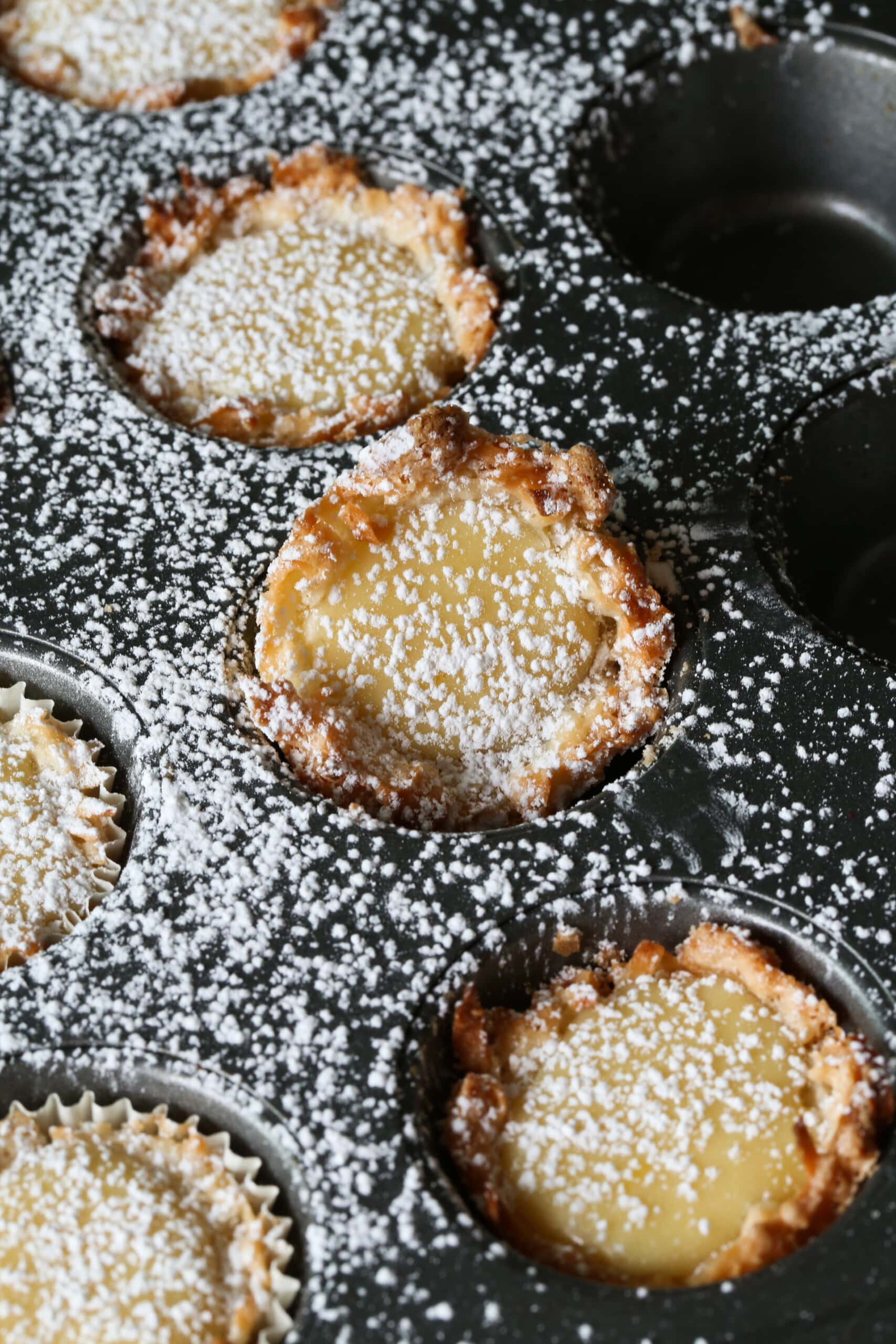 Lemon Tarts in a mini muffin pan dusted with powdered sugar
