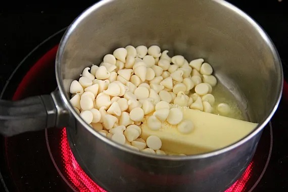 White chocolate chips and butter in a saucepan