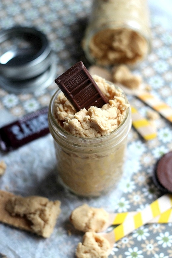 A jar of Peanut Butter Cup Spread with a mini Hershey chocolate bar sticking out the top