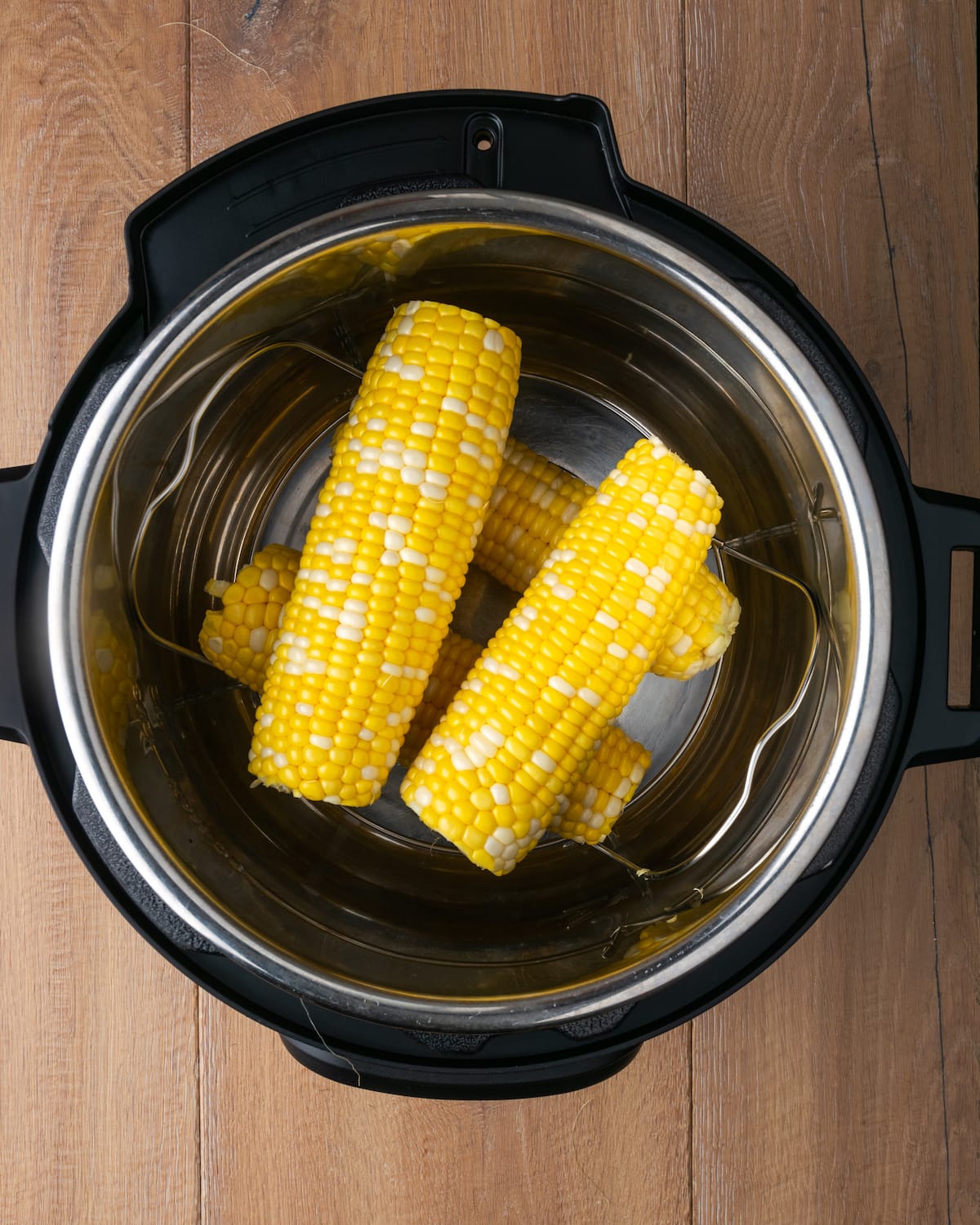 Top view of shucked ears of corn inside an Instant Pot.