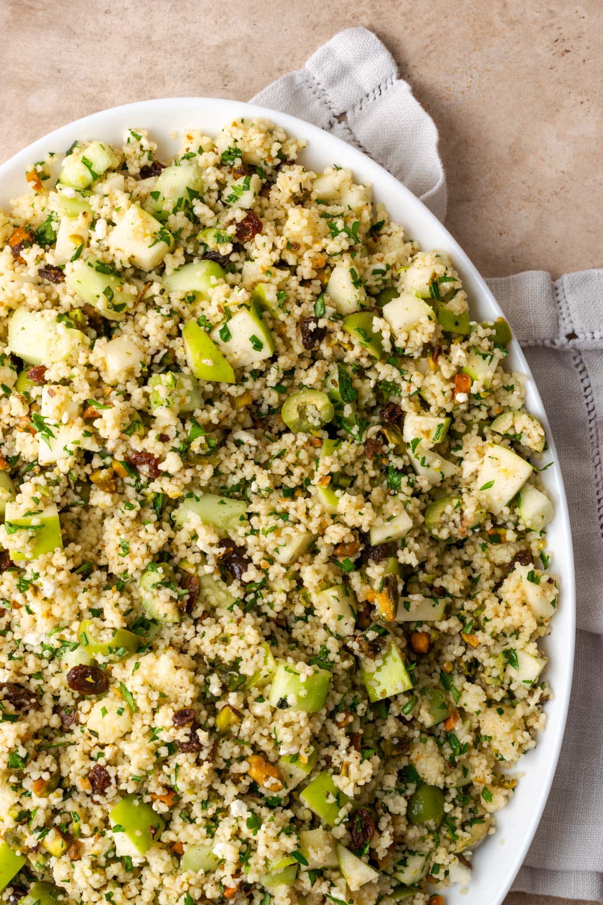 Top view of a large platter of Mediterranean couscous salad.