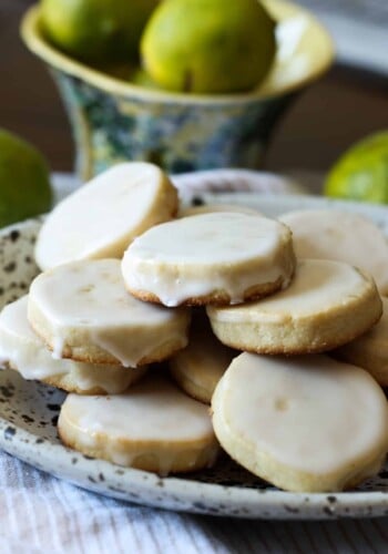 lime shortbread coated in icing stacked on a plate