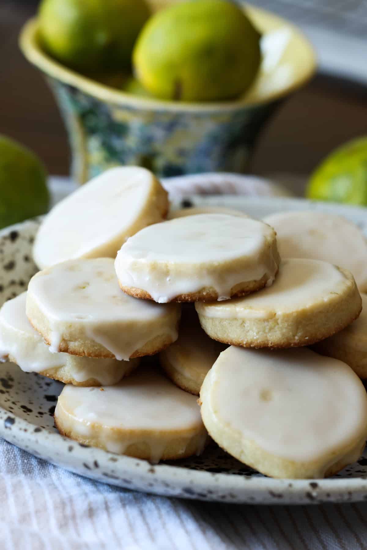 lime shortbread coated in icing stacked on a plate