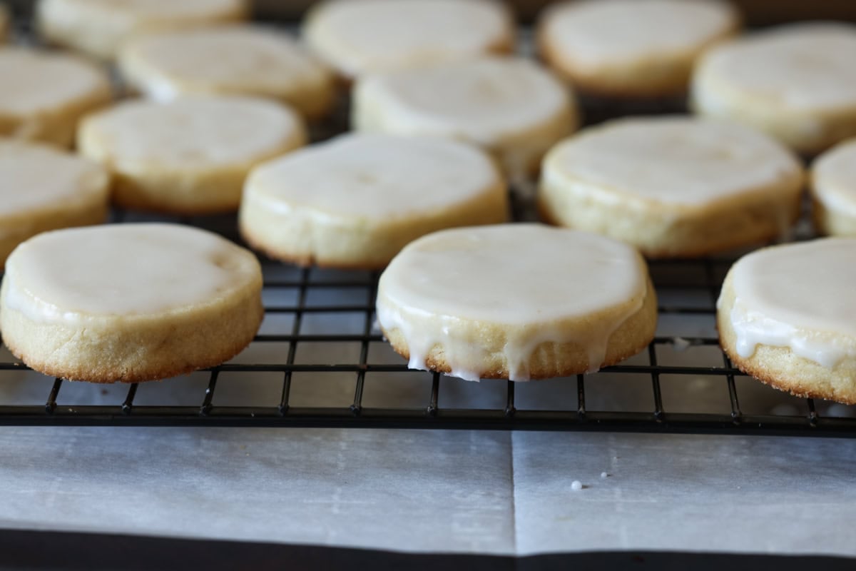 shortbread cookies dipped in icing on a wire cooling rack