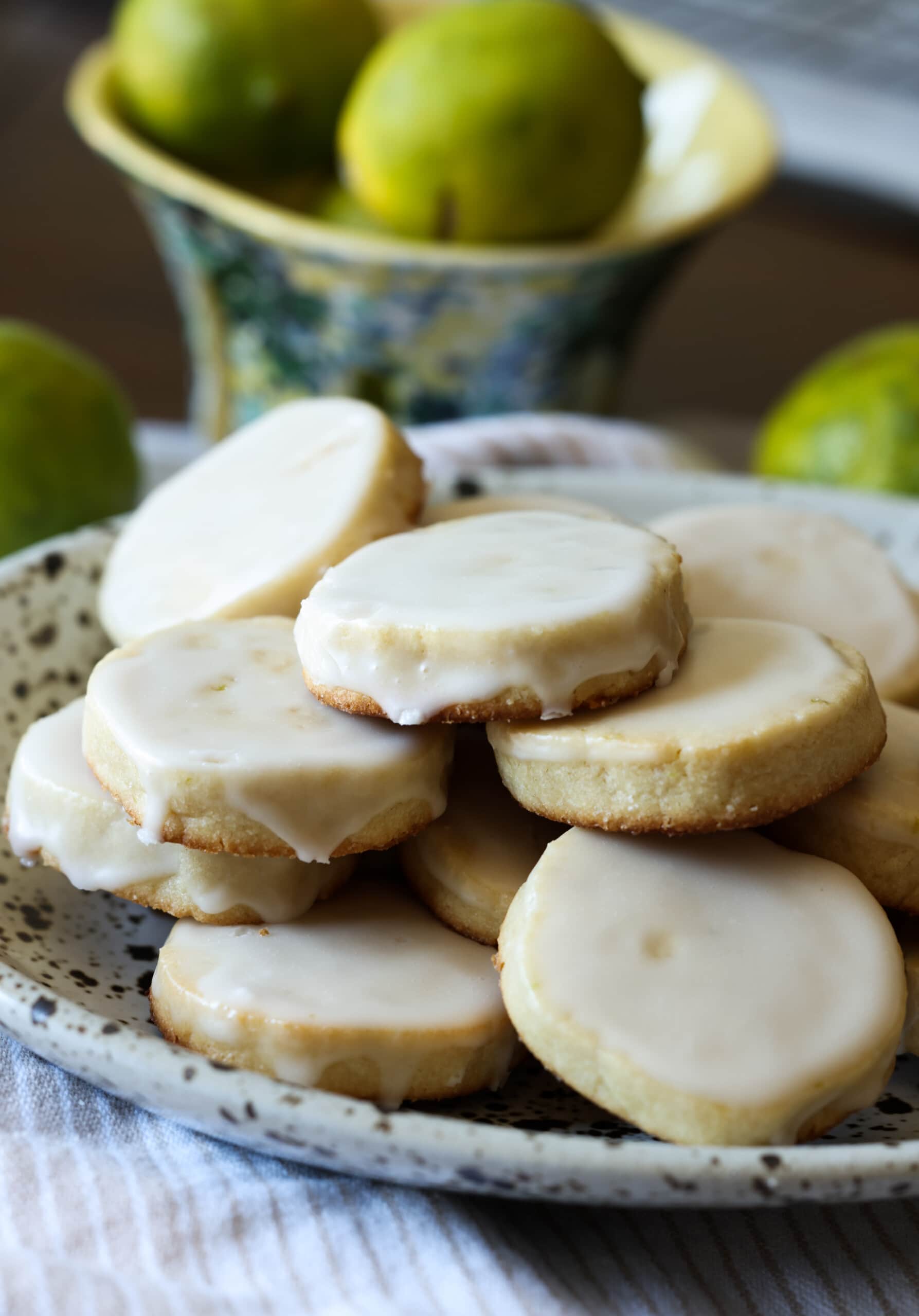 lime shortbread coated in icing stacked on a plate